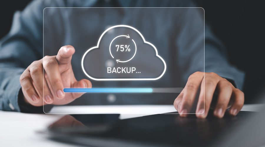 Hands interacting with holographic cloud backup progress bar — automated, secure, and continuous data backups powered by McNallan Technology Solutions Technology for MN enterprises