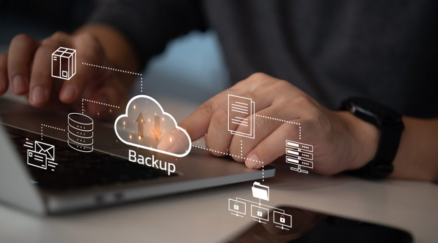 User interacting with “Backup” cloud icon surrounded by server, email, and file icons — end-to-end data protection strategy for Twin Cities businesses by McNallan Technology Solutions Technology