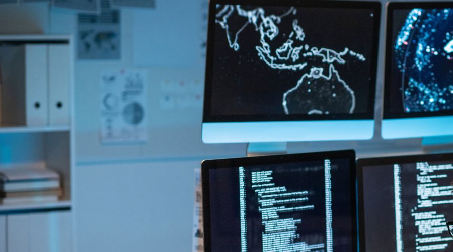 Security operations center with real-time network maps and code monitoring — showcasing McNallan Technology Solutions Technology’s proactive IT support for Minneapolis enterprises